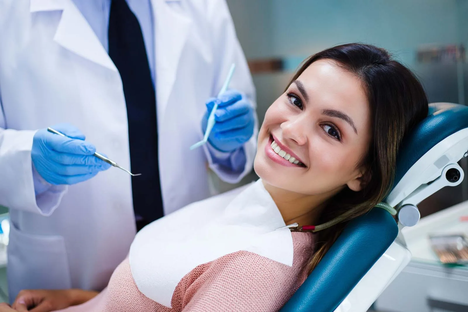 A relaxed patient smiling in the chair during a root-end procedure consultation